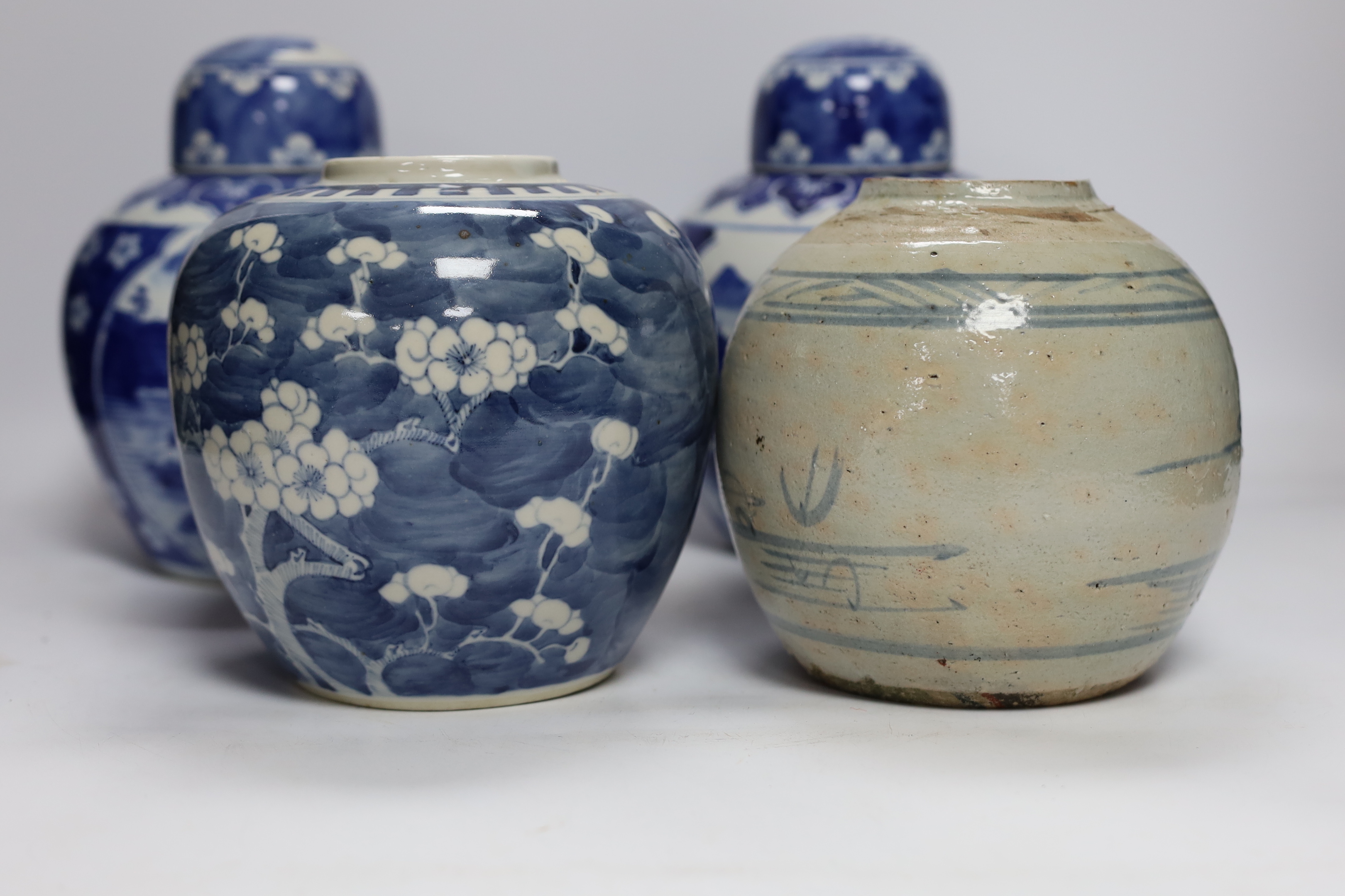 Four Chinese ginger jars, including a blue and white pair with covers and a prunus flower example, largest 21cm high